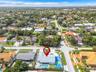 Corner lot property featuring a private swimming pool, multi-use hardscaped sports court, and concrete tile roofing