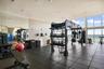Fitness center featuring floor-to-ceiling windows, full-wall mirrors, and durable rubber flooring