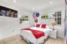 Bright room featuring neutral-toned tile flooring, recessed ceiling lighting, and two multi-pane windows with grid detailing