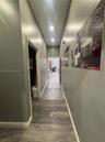 Hallway featuring wood-finish flooring, recessed ceiling lighting, and neutral wall paint