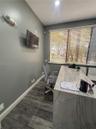 Room featuring wood-finish flooring, recessed lighting, and a large horizontal window equipped with adjustable blinds