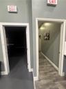 Interior space featuring dual doorways with white trim, wood-finish flooring, and recessed lighting