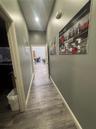 Hallway featuring wood-finish flooring, neutral-toned walls, and recessed ceiling lighting