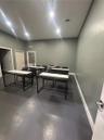 Interior space featuring neutral wall paint, recessed lighting, and solid-surface flooring