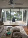 Expansive screened balcony with water views and tropical landscaping
