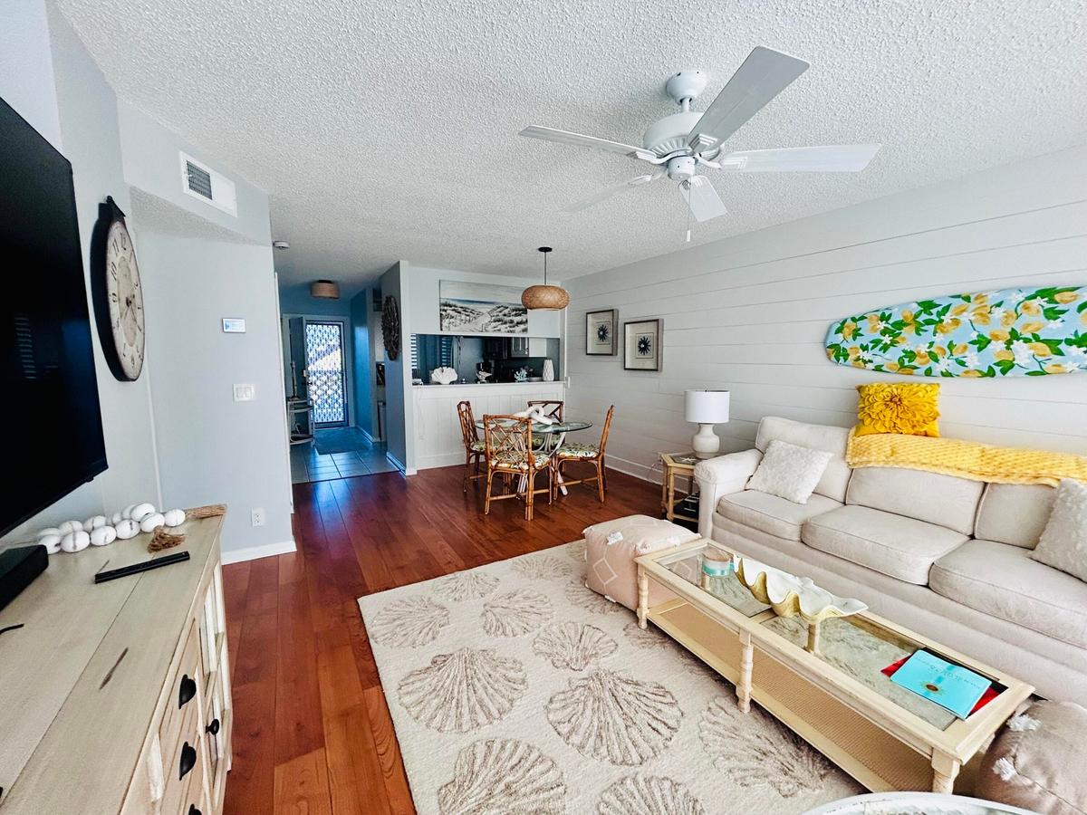 Open concept living area featuring wood-finish flooring