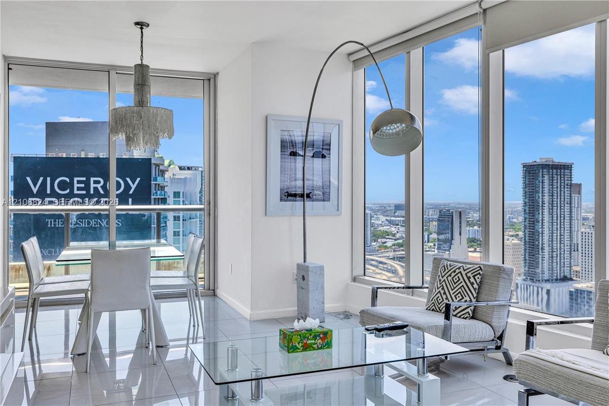 Floor-to-ceiling windows, polished tile flooring, and integrated ceiling-mounted light fixtures