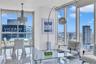 Floor-to-ceiling windows, polished tile flooring, and integrated ceiling-mounted light fixtures