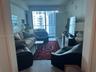 Floor-to-ceiling windows, wood-finish flooring, and an attached balcony