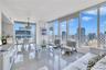 Floor-to-ceiling windows, polished tile flooring, built-in cabinetry, and pendant lighting