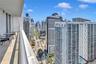 Private balcony featuring natural stone flooring and a tubular metal railing with a skyline cityscape backdrop