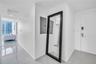 Neutral-toned ceramic tile flooring, solid-core interior door, and electronic keypad entry lock