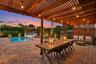 Residence 1753 (Right Side) – Private spacious backyard oasis, heated pool, wooden pergola and new flat roof with outdoor string lights, and a mounted