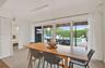 Residence 1747 (Left Side) – Dining area overlooking the outdoor oasis, featuring hurricane-impact sliding glass doors.
