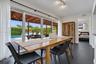 Residence 1747 (Left Side) – Kitchen featuring white cabinetry, granite countertops, stainless steel appliances, and a spacious dining area with hurri