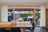 Residence 1753 (Right Side) – Open-concept dining area overlooking the pool, featuring large hurricane-impact sliding glass doors.