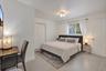 Residence 1747 (Left Side) – Spacious Bedroom 2 featuring an en-suite bathroom, large closet.