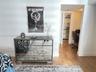 Wood-finish flooring and walk-in closet with built-in shelving