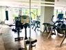 Fitness center featuring tile flooring, floor-to-ceiling windows, and recessed lighting