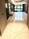 Polished terrazzo flooring with integrated curved metal inlay, large-format glass window wall, recessed ceiling cove lighting, and wall-mounted linear