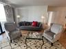 Living area featuring wood-finish flooring and neutral wall paint