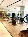 Fitness room featuring wall-to-wall mirrors, neutral tile flooring, and recessed ceiling lighting
