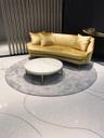 Polished stone flooring with inlaid organic patterns and vertical slat architectural screen
