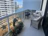 Private balcony featuring large-format tile flooring and a glass-paneled aluminum railing