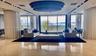Expansive room featuring polished stone flooring with inlaid curvilinear detailing, a large multi-tiered circular chandelier, recessed ceiling lightin