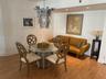 Wood-finish flooring, recessed lighting, and ornate metal chandelier