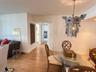 Wood-finish flooring and intricate metal lantern-style chandelier