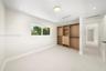 Room featuring neutral wall-to-wall carpeting, recessed ceiling lighting, a rectangular window, and custom built-in cabinetry with integrated shelving