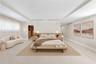 Virtually Staged: Spacious room featuring a recessed tray ceiling, neutral wall-to-wall flooring, built-in wooden headboard with integrated side table