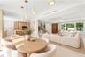 Virtually Staged: Open-concept interior featuring light wood-finish cabinetry, a floating staircase with glass railing, recessed lighting, pendant fix