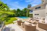 Virtually Staged: Outdoor living area featuring a paved patio, swimming pool with integrated spa, manicured lawn, and built-in stainless steel grill