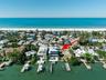 Count them 1, 2, 3 homes between the home and the white sandy beach