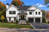 Front Exterior | Digitally Enhanced – Striking modern farmhouse design featuring James Hardie siding, contrasting black accents, architectural rooflin