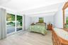 Ground level bedroom with sliding doors out to backyard.