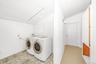 Hallway upstairs with washer dryer