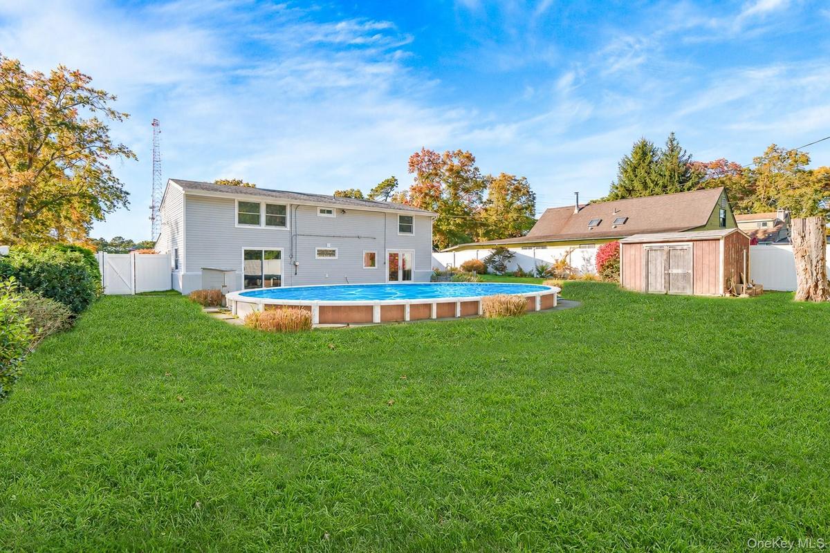 With semi in-ground pool and yard