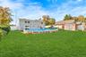 With semi in-ground pool and yard