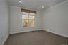 Primary with window looking to private back area