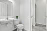 Dually-accessed full bathroom with a half bath easily accessible to the pool. Virtually staged.