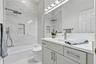 Full hall bath shared by bedrooms 3 and 4.