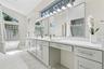 Modern and sleek primary bathroom vanity with make up area.