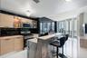 Floor-to-ceiling windows, polished tile flooring, built-in cabinetry with integrated shelving, and patterned wall cladding