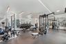 Fitness center featuring mirrored walls, resilient flooring, and integrated linear lighting