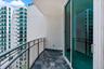 Private balcony featuring polished stone flooring, metal mesh railing, and floor-to-ceiling sliding glass doors