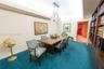 Built-in floor-to-ceiling wood shelving, multi-arm metal chandelier, and recessed ceiling lighting