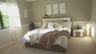 Neutral wall tones featuring mid-height chair rail molding, plush wall-to-wall carpeting, and a multi-pane window